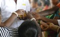 Indian man gives laddu treats to pilgrims