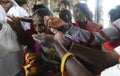 Indian man gives laddu treats to pilgrims