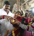 Indian man gives laddu treats to pilgrims
