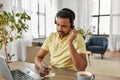 Indian man with headset and laptop working at home Royalty Free Stock Photo