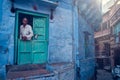 Indian man and his blue house in streets, Jodhpur, Rajasthan, India