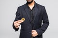 Indian business man holding golden bitcoin in hand isolated on a white background Royalty Free Stock Photo