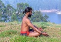 Indian man meditating on green grass Royalty Free Stock Photo