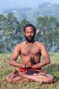 Indian man meditating on green grass Royalty Free Stock Photo