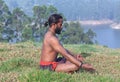 Indian man meditating in lotus yoga pose Royalty Free Stock Photo