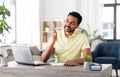 Indian man with notebook and laptop at home office Royalty Free Stock Photo