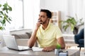 Indian man with notebook and laptop at home office Royalty Free Stock Photo