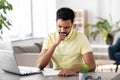 Indian man with notebook and laptop at home office Royalty Free Stock Photo
