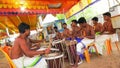 Man an playing on a Chenda Melam rhythmic orchestra