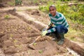 Indian man professional horticulturist with garden mattock