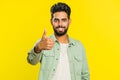 Indian man raises thumbs up agrees or gives positive reply recommends advertisement likes good idea
