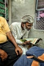 Indian Man reading Newspaper in Train