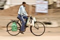 Indian Man rides on bicycle , Panning a camera