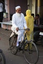 Indian man riding bicycle in the narrow streets of old town, Bun