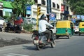 Indian man riding scooter