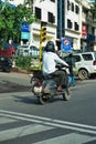 Indian man riding scooter