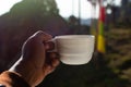 Indian man`s hand holding clay cup of hot Darjeeling Tea in hotel room at the hill station Royalty Free Stock Photo