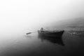 Indian man sailing on the boat on sacred river Ganges at cold foggy winter morning Royalty Free Stock Photo