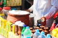 A man selling products such as Frooti, yogurt, Lassi