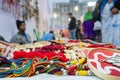 Indian man selling coloutful handmade jewelleries