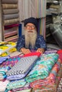 Indian man selling textile in a shop at Chandni Chowk, Delhi, In