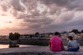 An Indian man sitting with his son on the ramparts of the ancient Vellore Fort