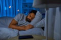 indian man sleeping in bed at home at night Royalty Free Stock Photo