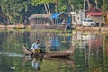 indian man in small boat in backwaters Royalty Free Stock Photo