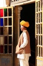 Indian man standing by the doorway at Mehrangarh Fort, Jodhpur,