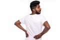 Indian Young man suffering from Back Pain or injury isolated over white background Royalty Free Stock Photo