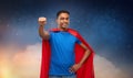 Indian man in superhero cape makes winning gesture Royalty Free Stock Photo