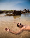 Indian man swimming at ocean beach