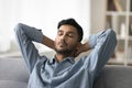 Indian man take break leaned on soft couch Royalty Free Stock Photo