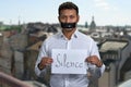 Indian man with taped mouth holding poster with inscription Silence. Royalty Free Stock Photo