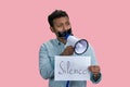 Indian man taped mouth speaks in megaphone. Royalty Free Stock Photo