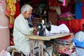 Indian Man using Sewing Machine at Market
