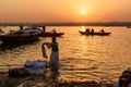 Indian man washing clothes in holy water of river Ganga in sunrise. Varanasi. India Royalty Free Stock Photo