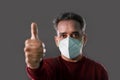 Happy Indian Man wearing a N95 mask and showing thumbs up for protection against virus, dust, pollution and smog