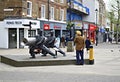 An Indian Man wearing a Orange Turban Looking at a Statue in Staines High Street