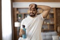 Indian man wiping sweat and drinking water during sport Royalty Free Stock Photo