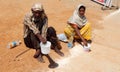 Indian man and woman seek alms or beg on road to temple on festival