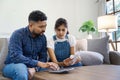 Indian married couple calculating bills, discussing planning budget together, serious wife and husband looking at Royalty Free Stock Photo