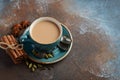 Indian masala chai tea. Spiced tea with milk on dark rusty background.