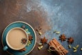 Indian masala chai tea. Spiced tea with milk on dark rusty background.