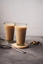 Indian masala chai tea, traditional glasses with strainer and chai spices. Royalty Free Stock Photo