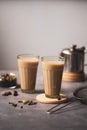 Indian masala chai tea. Two glasses with traditional glasses with strainer and chai spices. Royalty Free Stock Photo