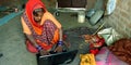 An indian matured woman operating computer internet laptop in the home