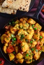 Indian meal in cast iron pan - aloo gobhi with chapati Royalty Free Stock Photo