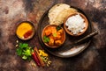 Indian meat dish with rice and naan bread.
