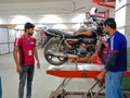 an indian mechanic repairing hero bike at workshop in india January 2020